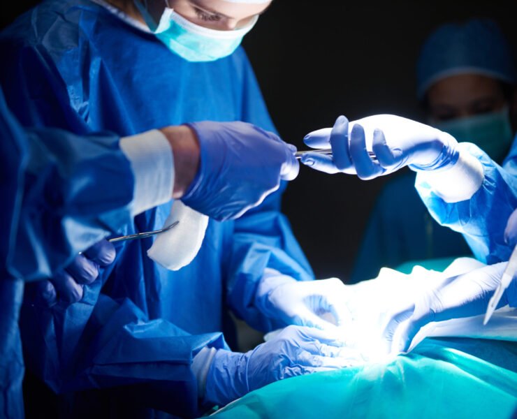 Surgeons passing scissors to each other